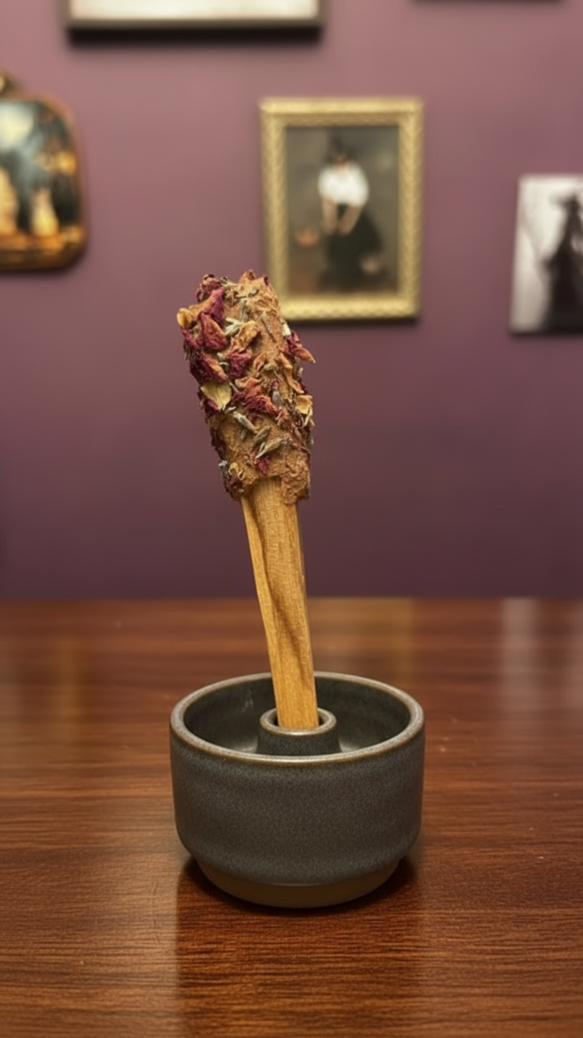 Palo santo stick with botanical-covered incense coating, displayed in a dark ceramic holder; holder not included.